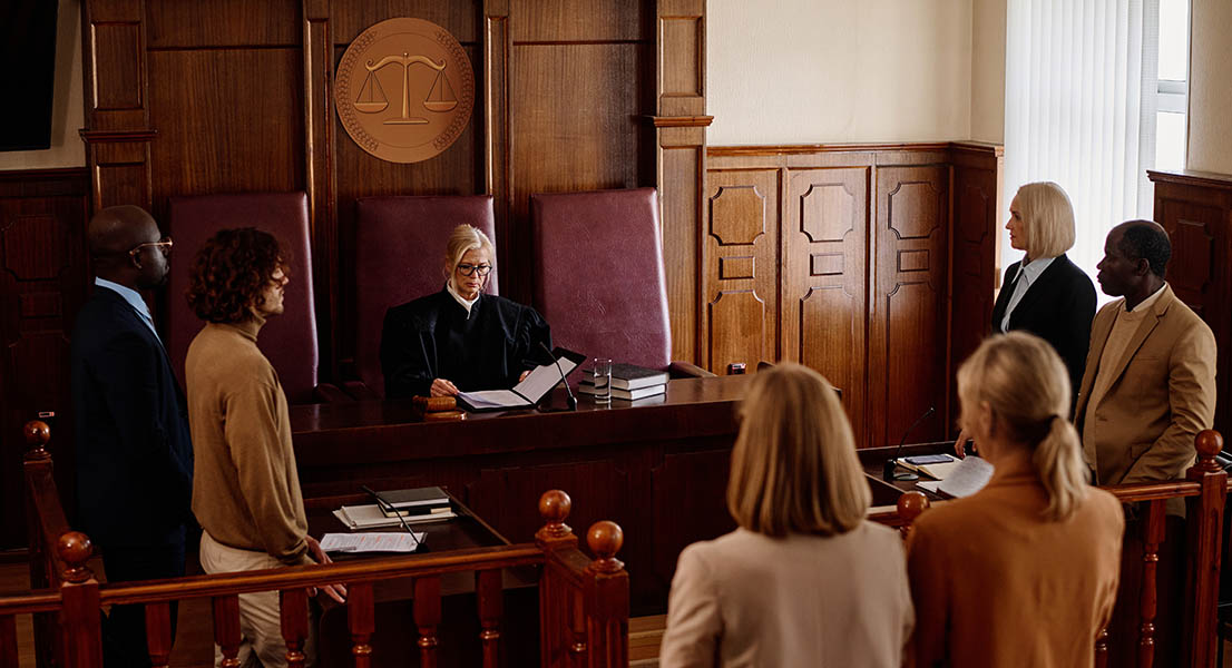 A probation officer and a defendant studying legal vocabulary in a courtroom setting.